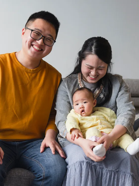 A family with a baby on the couch